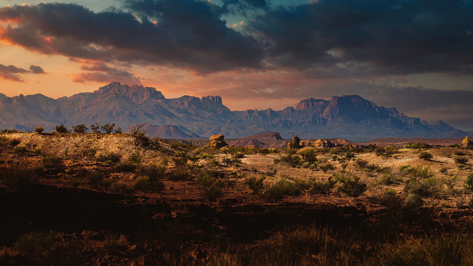 Desert mountains beneath storm clouds and sunset light in Big Bend National Park