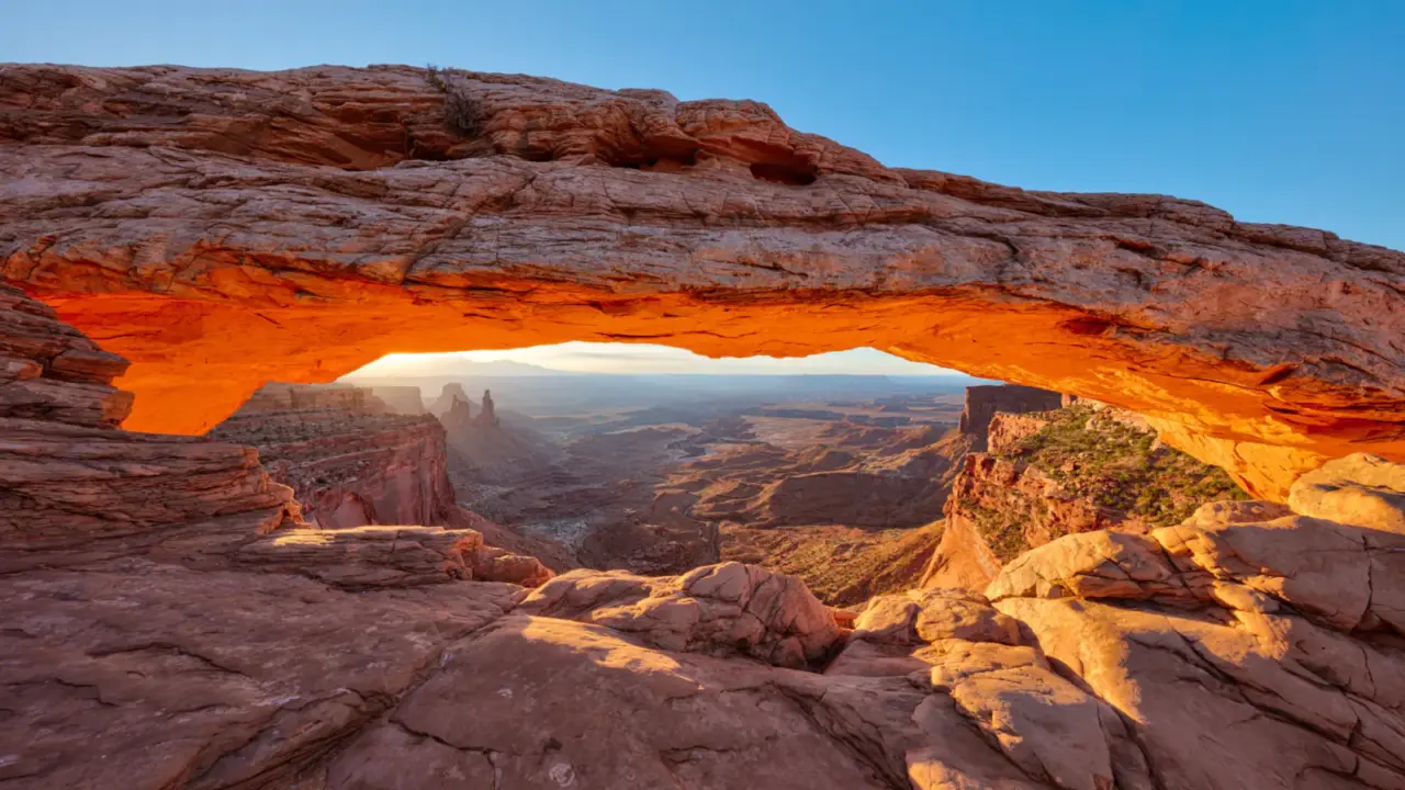 Sunrise glowing beneath Mesa Arch in Canyonlands National Park