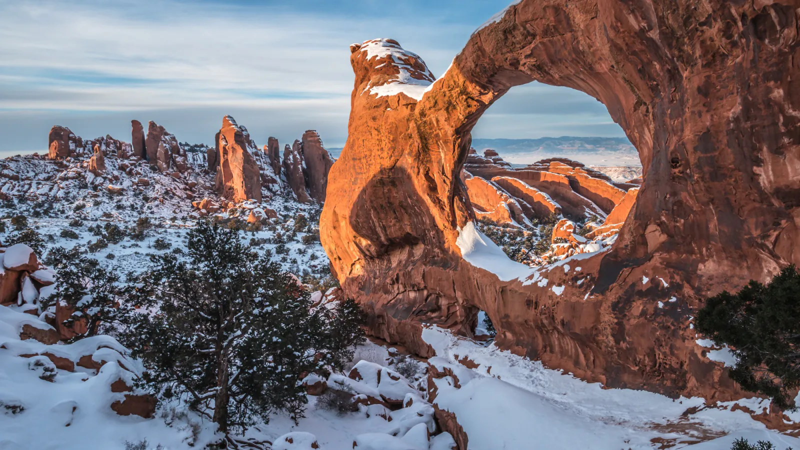 Snowy sunset at Double O Arch in Arches National Park
