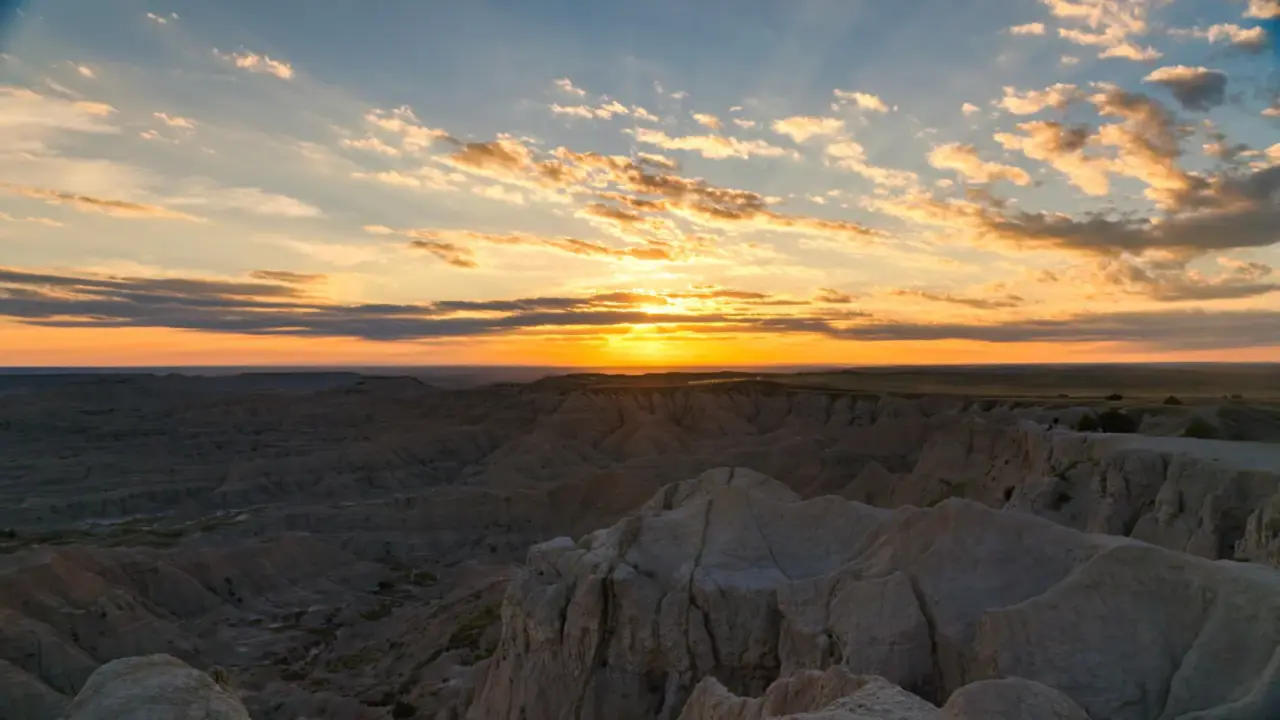 Sunset above layered formations in Badlands National Park